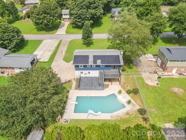 an aerial view of a house with outdoor space pool seating area and yard