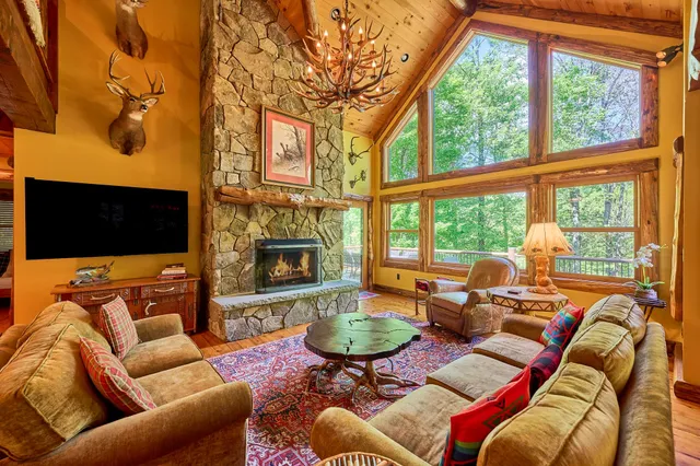 a living room with furniture fireplace and a large window