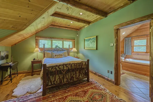 a bed sitting in a bedroom next to a window