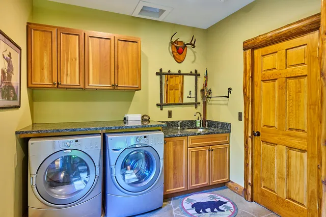 a utility room with a stove a washer and dryer