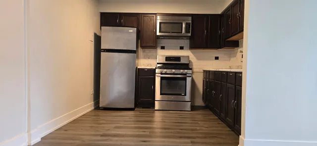 a kitchen with a refrigerator and a stove