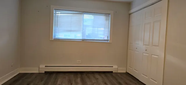 a view of room with window and hardwood