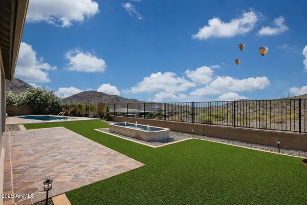 a view of a swimming pool with a yard and lake view