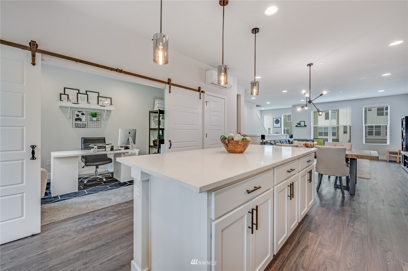 a kitchen with kitchen island a wooden floor and white appliances