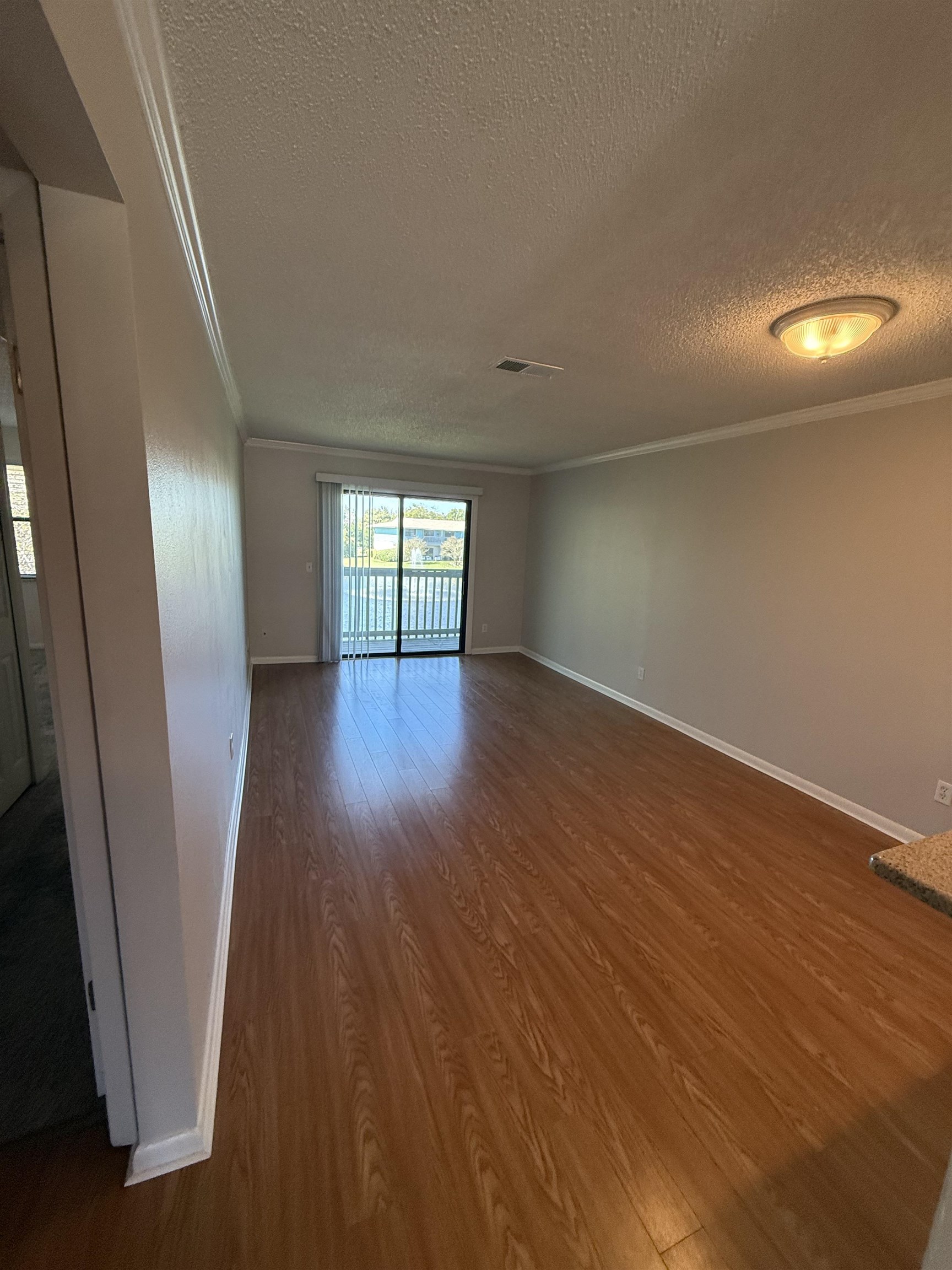 650 West Pope Road, Unit 225 St. Augustine, FL 32080 - Photo 5 of 21 an empty room with wooden floor and windows