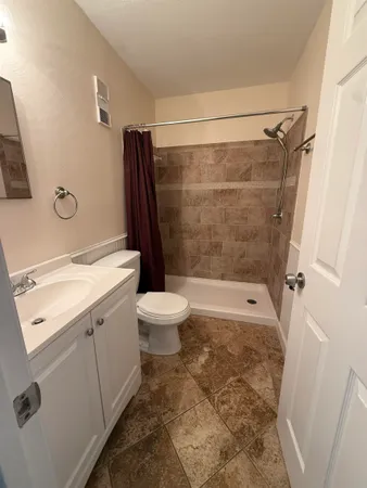 a bathroom with a sink toilet and shower
