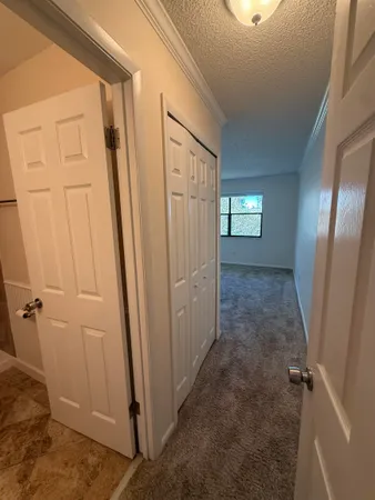a view of a hallway with closet area