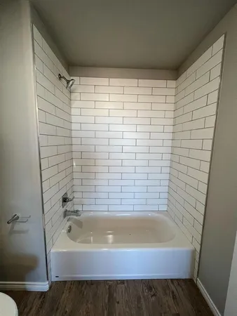 a bathroom with a bathtub and shower