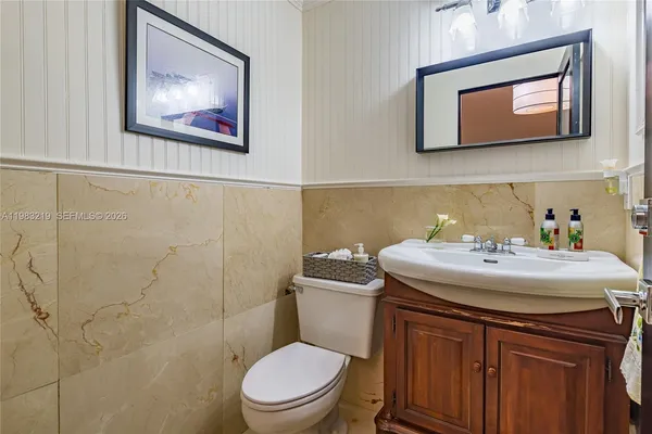 a bathroom with a toilet a sink and mirror