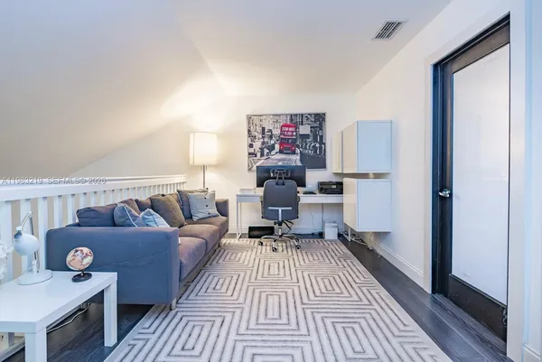 a living room with furniture and a rug