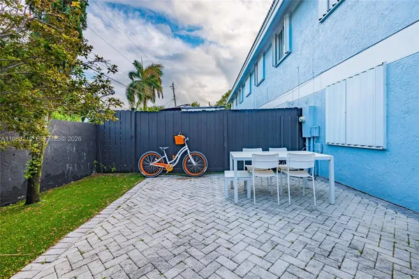 a view of a chairs and table in backyard