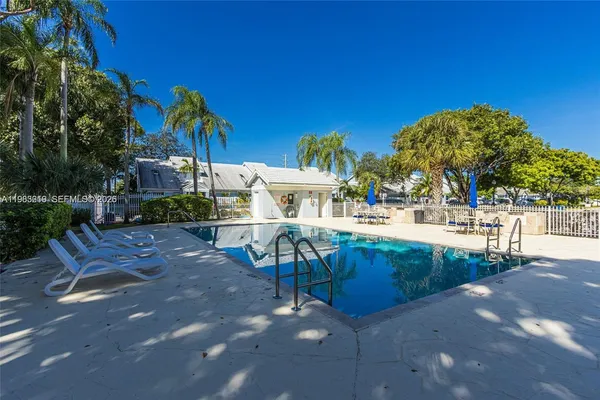 a view of swimming pool with outdoor seating and plants