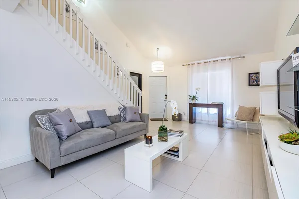 a living room with furniture and a flat screen tv