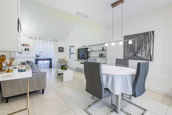 a living room with furniture and kitchen view