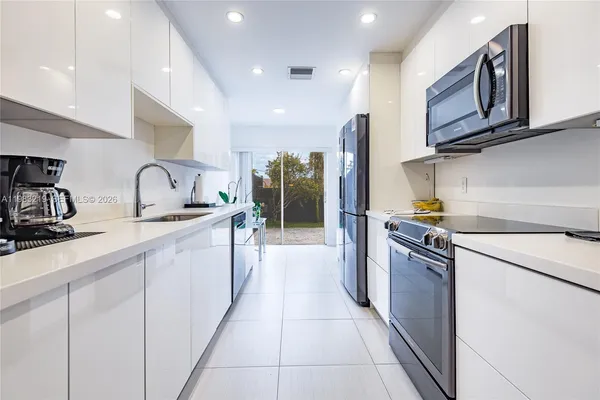 a kitchen with stainless steel appliances granite countertop a sink and cabinets