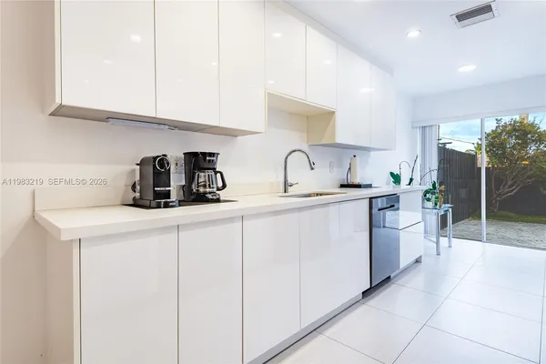 a kitchen with cabinets a sink and appliances