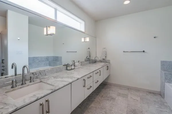 a bathroom with a granite countertop sink double and mirror