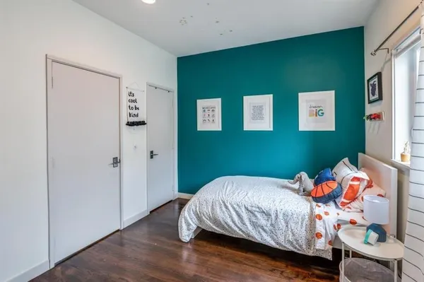 a bedroom with bed and a window