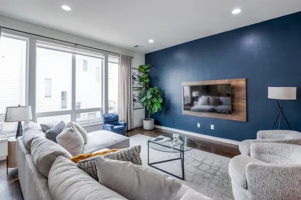 a living room with furniture and kitchen view