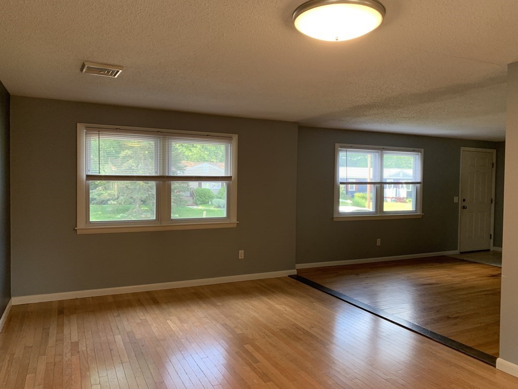 34 Portulaca Drive Springfield, MA 01129 - Photo 12 of 20 an empty room with wooden floor and windows