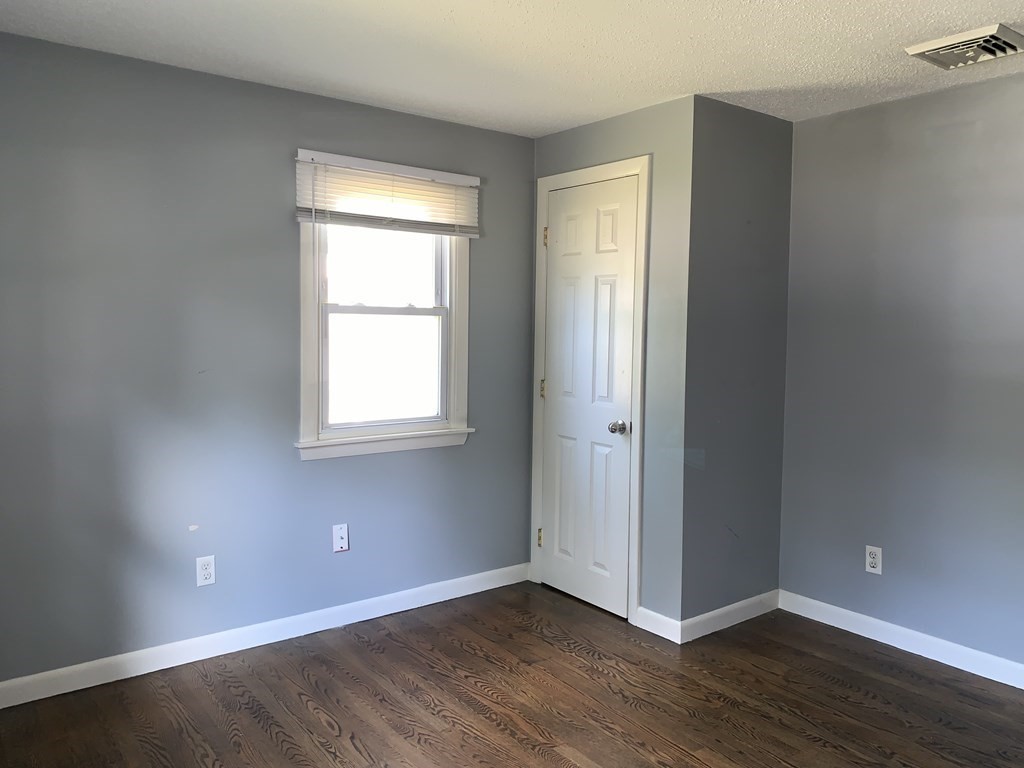 34 Portulaca Drive Springfield, MA 01129 - Photo 15 of 20 an empty room with wooden floor and windows