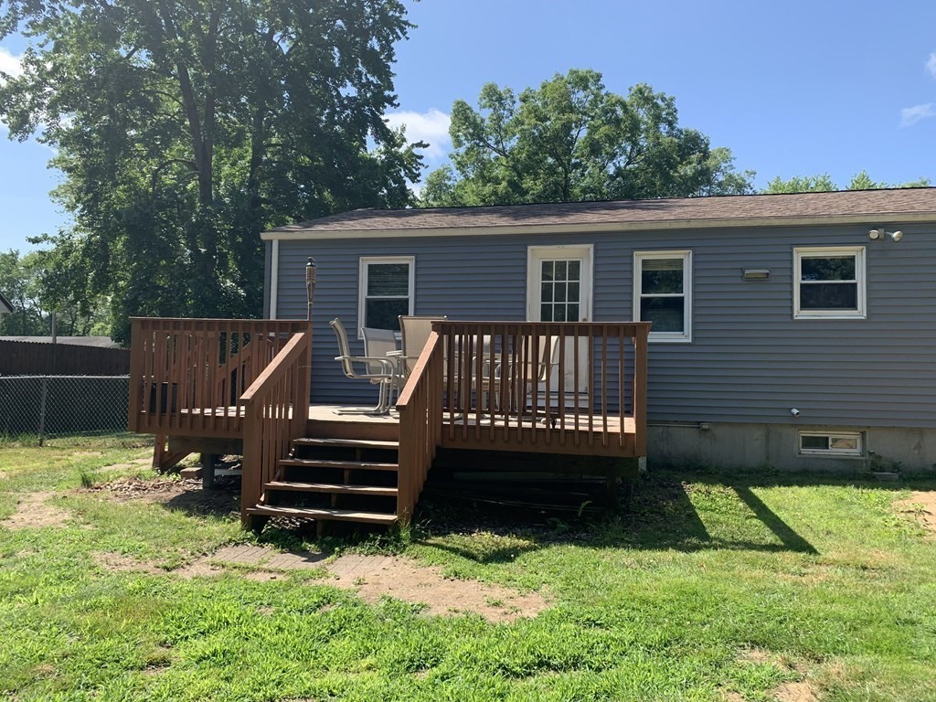 34 Portulaca Drive Springfield, MA 01129 - Photo 4 of 20 a view of a house with a yard and a wooden deck