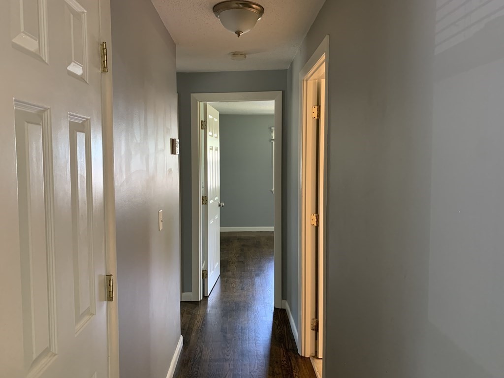 34 Portulaca Drive Springfield, MA 01129 - Photo 9 of 20 a view of a hallway with wooden floor