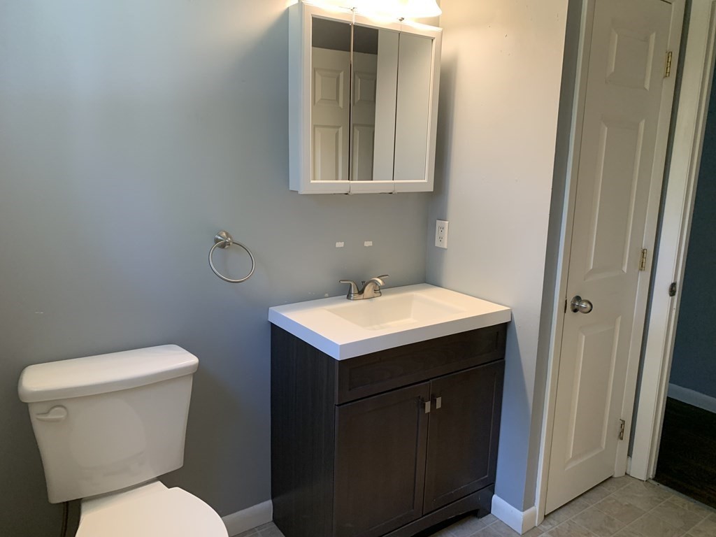 34 Portulaca Drive Springfield, MA 01129 - Photo 10 of 20 a bathroom with a toilet sink and mirror