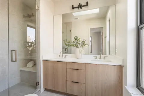 a bathroom with a double vanity sink mirror and toilet