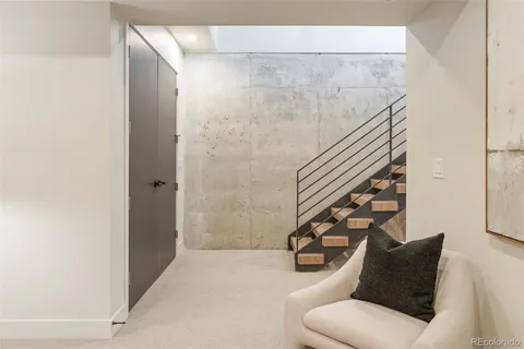 a view of a hallway with wooden floor and stairs