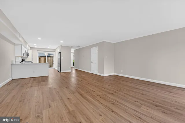 a view of a kitchen with wooden floor and a sink
