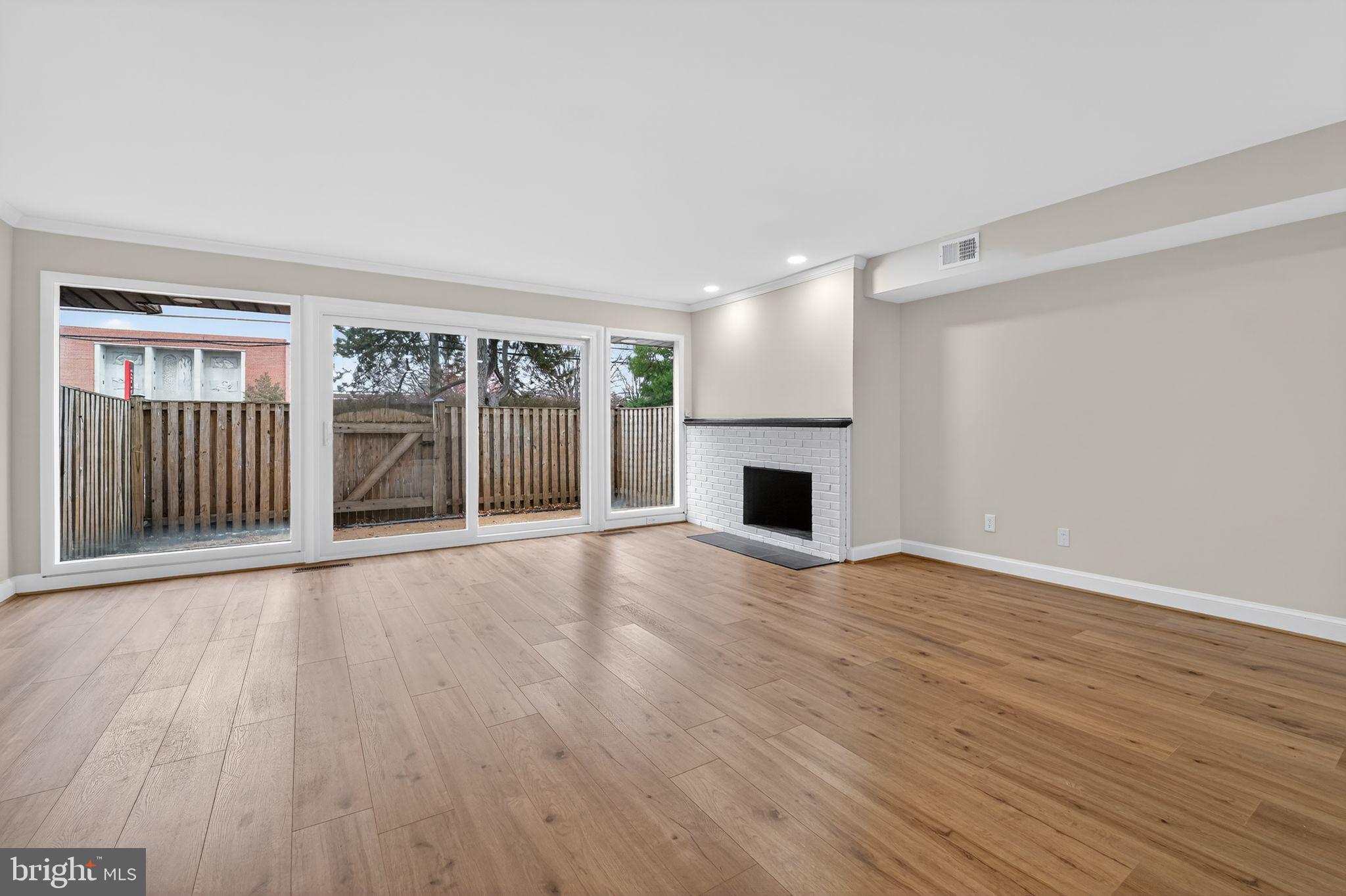 7344 Park Heights Avenue Baltimore, MD 21208 - Photo 13 of 33 a view of an empty room with wooden floor and a window