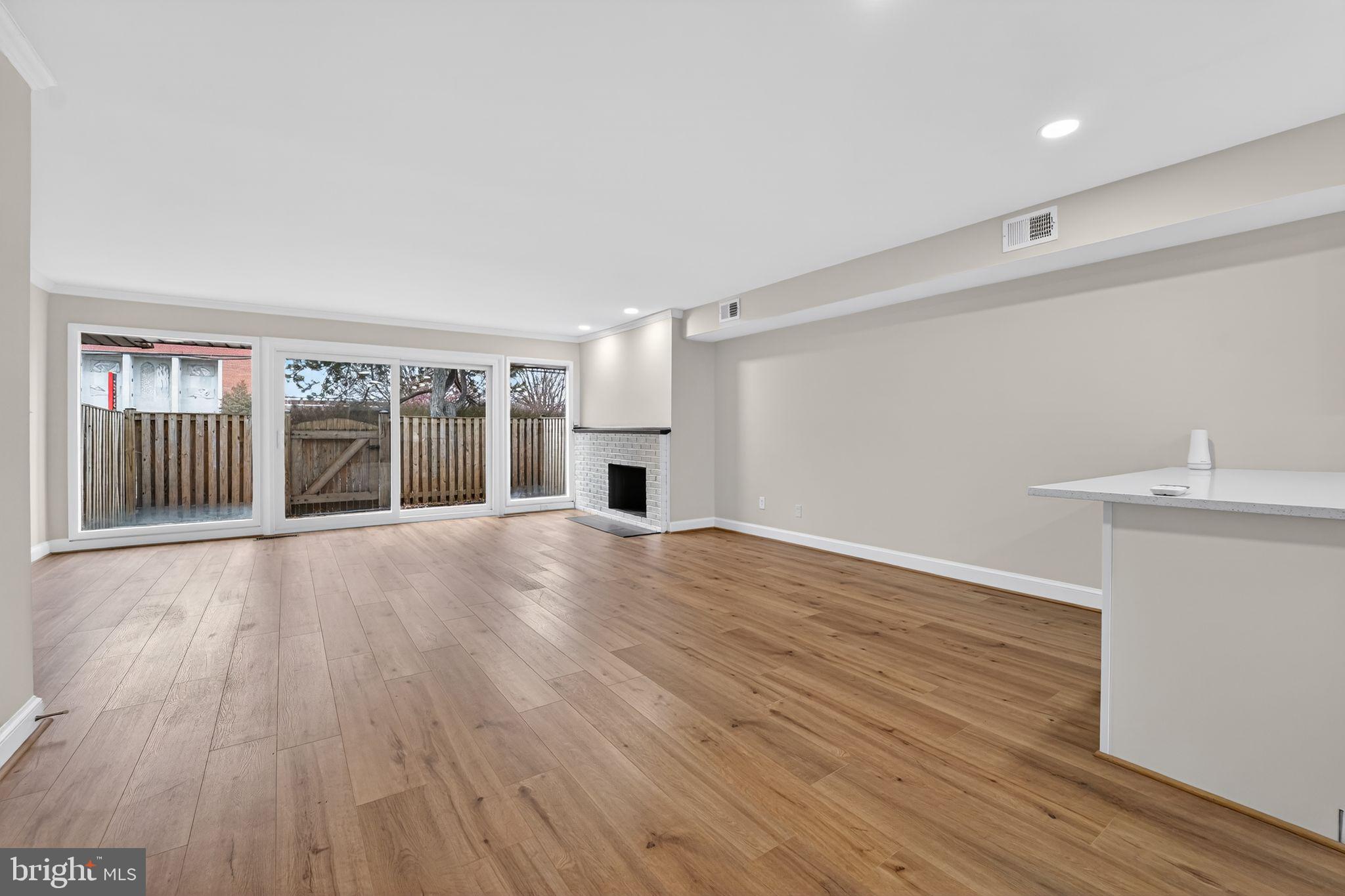 7344 Park Heights Avenue Baltimore, MD 21208 - Photo 14 of 33 a view of an empty room with wooden floor and a window