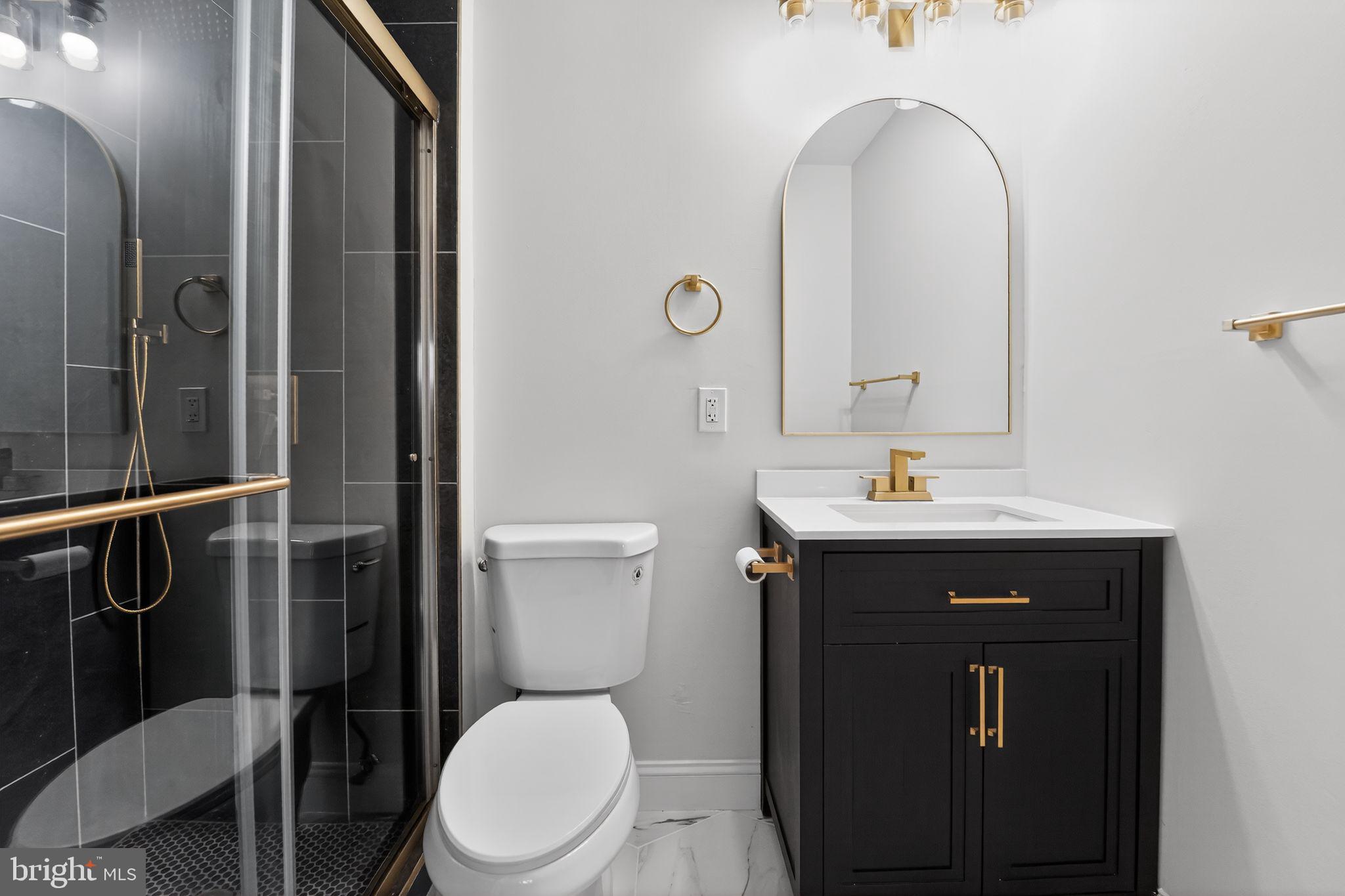 7344 Park Heights Avenue Baltimore, MD 21208 - Photo 15 of 33 a bathroom with a toilet sink and mirror