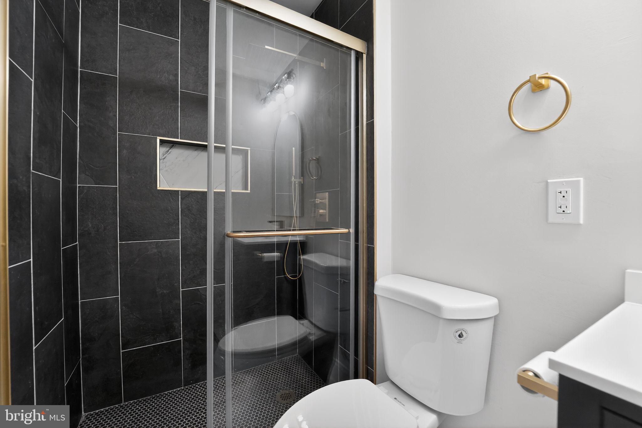 7344 Park Heights Avenue Baltimore, MD 21208 - Photo 16 of 33 a white toilet sitting next to a bathroom sink