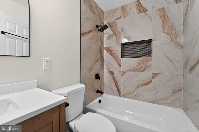 a bathroom with a toilet sink and bathtub