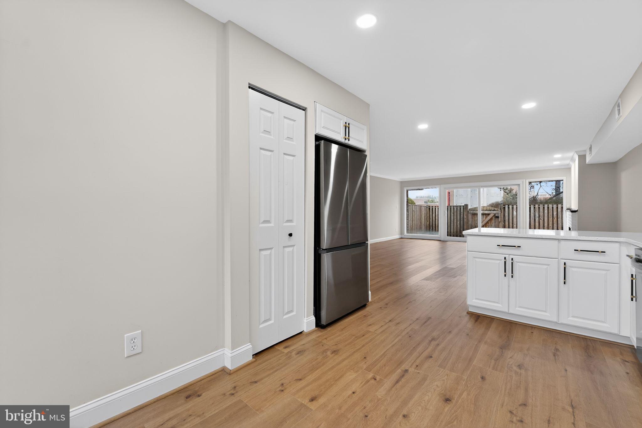 7344 Park Heights Avenue Baltimore, MD 21208 - Photo 10 of 33 a kitchen with white cabinets and stainless steel appliances