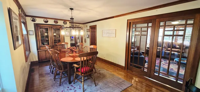 a view of a dining room with furniture and chandelier