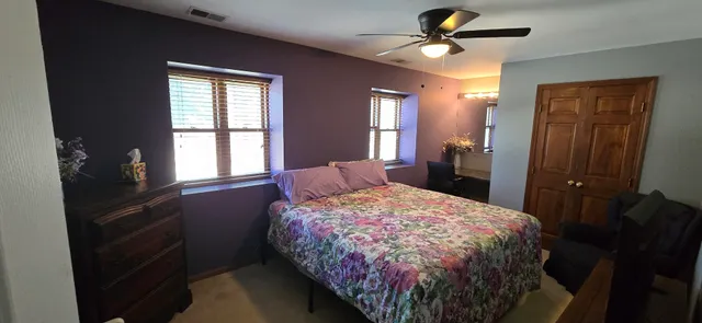 a bedroom with a bed and a chandelier