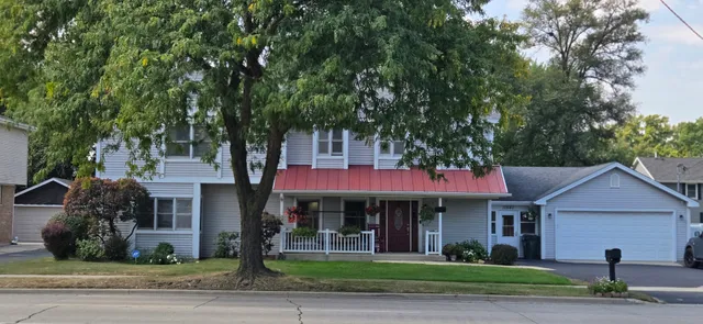 a front view of a house with a garden