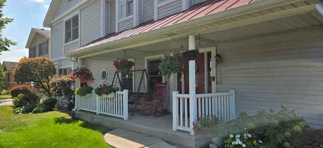 a view of a house with a small yard and plants