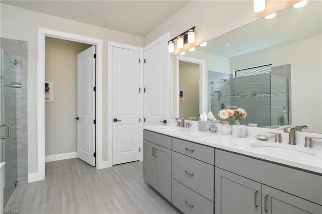 a bathroom with a double vanity sink and mirror