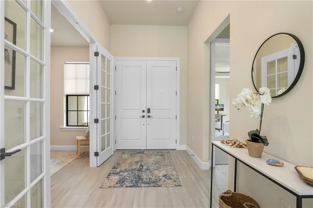 a view of a livingroom with wooden floor and a bathroom