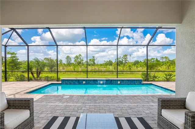 a view of swimming pool from a lounge chair