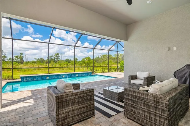a view of an empty room and floor to ceiling windows
