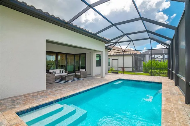 a front view of house with yard and swimming pool
