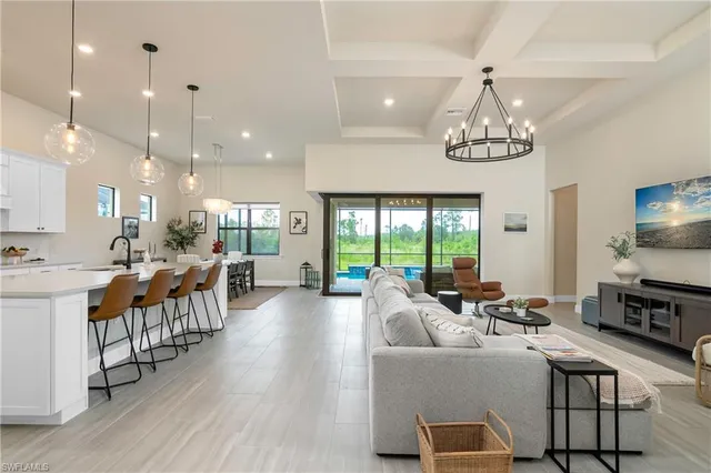 a living room with furniture a chandelier and a chandelier