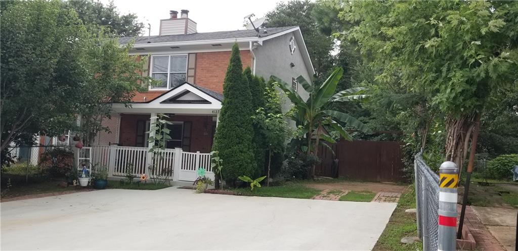 4127 Casey Trail Norcross, GA 30093 - Photo 1 of 1 a front view of a house with a yard and potted plants