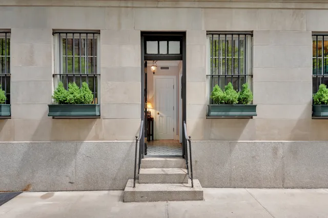 front view of a house with a potted plant