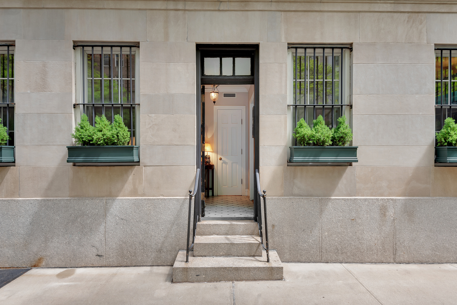 front view of a house with a potted plant
